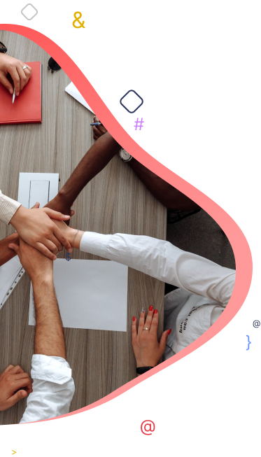 People joining hands over a table with documents and a red notebook